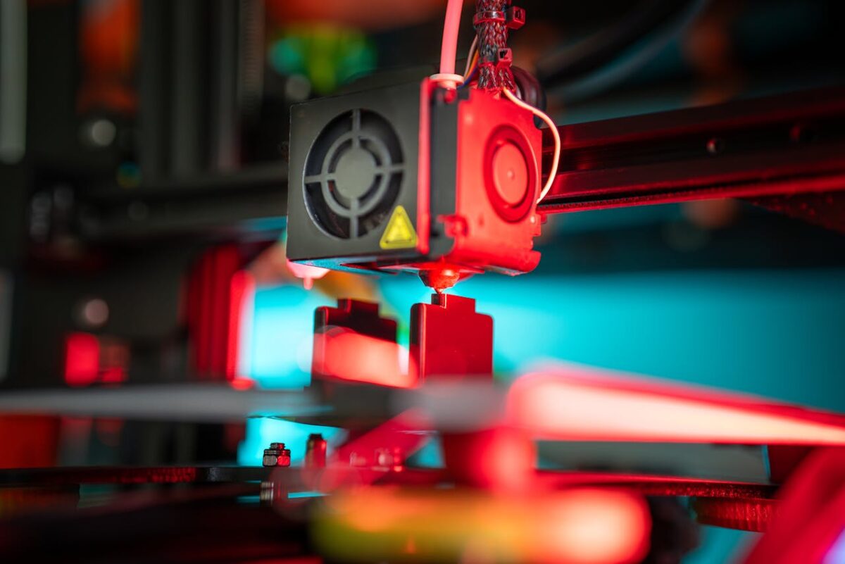 A vibrant close-up of a 3D printer in action creating a prototype.